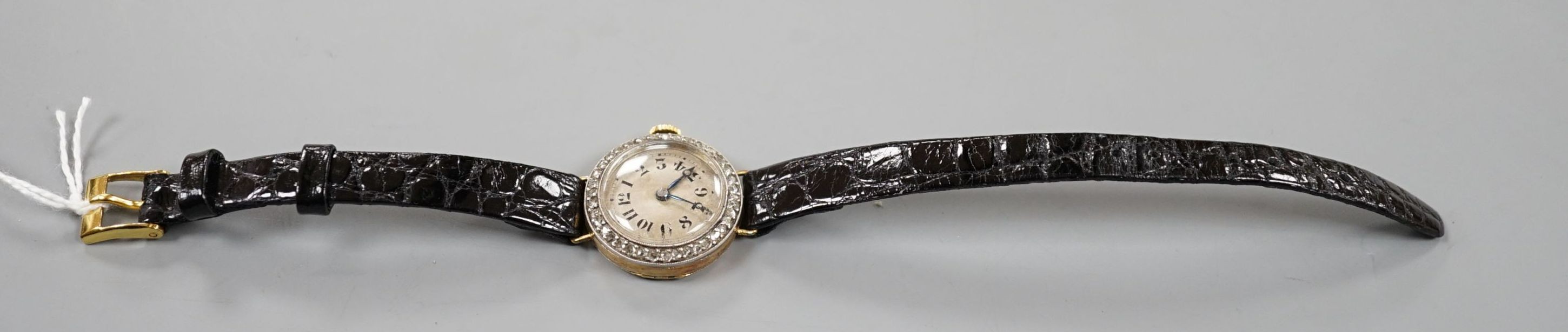 A lady's early 20th century 18k and diamond set manual wind wrist watch, on later leather strap